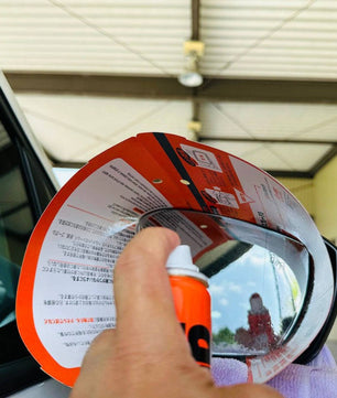 Applying Soft99 Glaco Mirror Coat Zero waterproof coating spray on car side mirror for rain protection