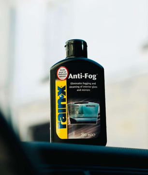 Rain-X Anti-Fog interior glass treatment bottle highlighting key benefits including fog prevention, improved visibility, and safe use on tinted windows.