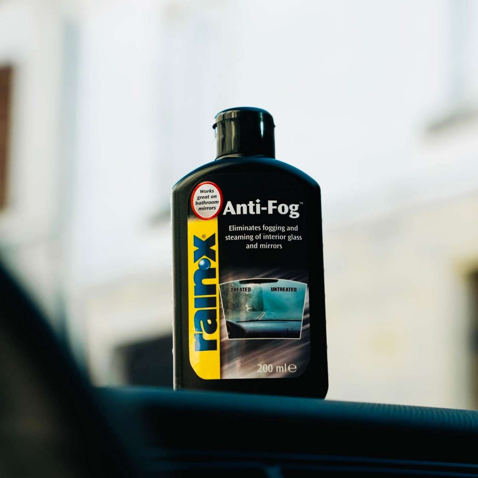Rain-X Anti-Fog interior glass treatment bottle highlighting key benefits including fog prevention, improved visibility, and safe use on tinted windows.