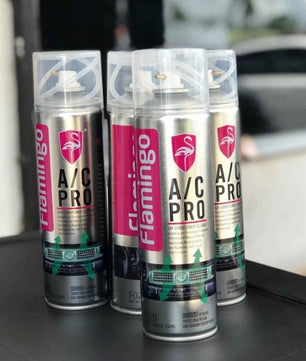 Three Flamingo A/C Pro air conditioner cleaner cans for removing odors and refreshing car AC systems.
