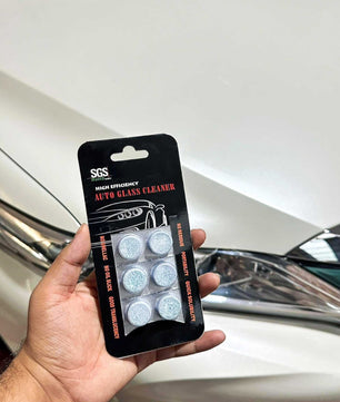 sgs auto glass cleaner tablet in hand using on a toyota harrier